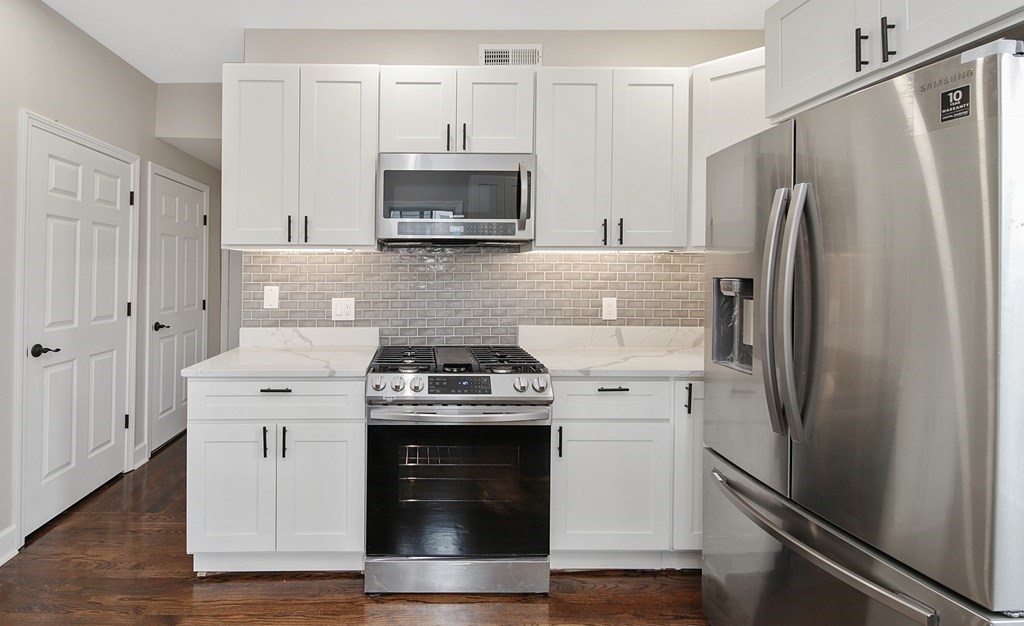 41 School Street, Unit 1 Boston, MA 02124 - Photo 14 of 25 a kitchen with a stove microwave and a refrigerator