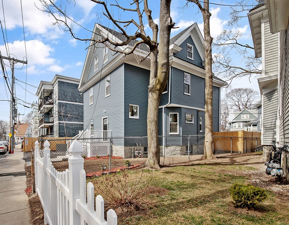 41 School Street, Unit 1 Boston, MA 02124 - Photo 20 of 25 a view of a brick house with many windows next to a road