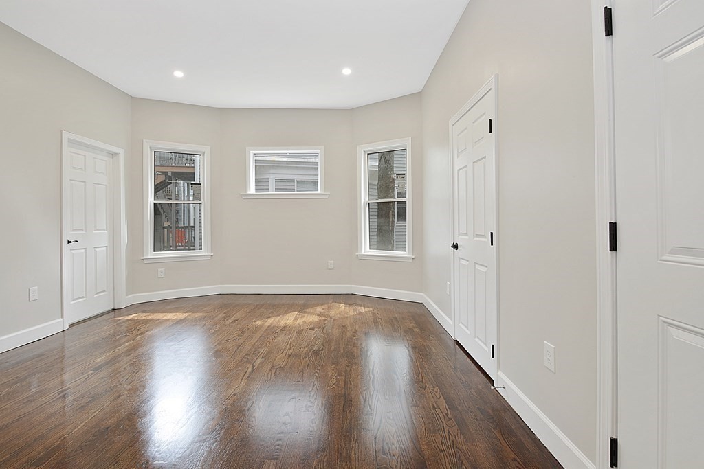 41 School Street, Unit 1 Boston, MA 02124 - Photo 3 of 25 a view of empty room with wooden floor and fan