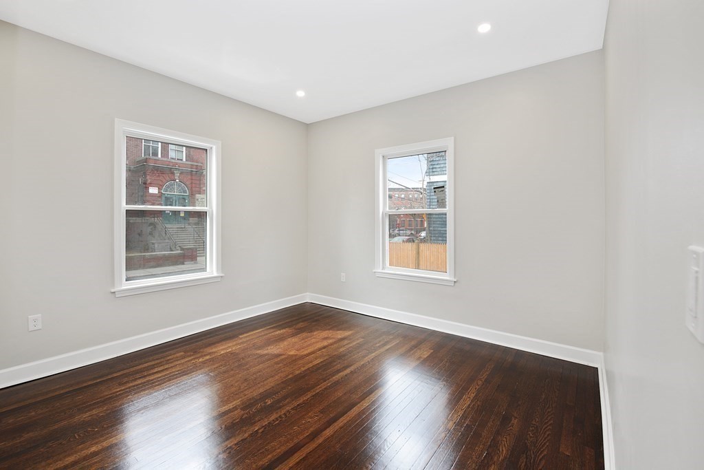 41 School Street, Unit 1 Boston, MA 02124 - Photo 4 of 25 a view of an empty room with wooden floor and a window
