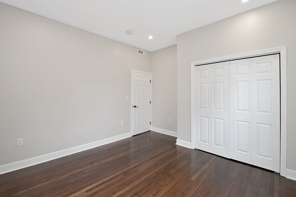 41 School Street, Unit 1 Boston, MA 02124 - Photo 5 of 25 a view of an empty room with wooden floor