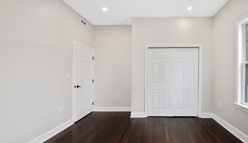 41 School Street, Unit 1 Boston, MA 02124 - Photo 6 of 25 a view of empty room with wooden floor and entryway
