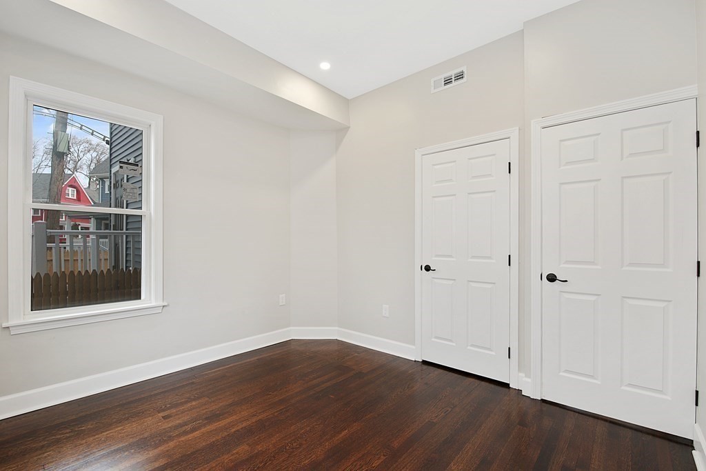 41 School Street, Unit 1 Boston, MA 02124 - Photo 8 of 25 a view of an empty room with wooden floor and window