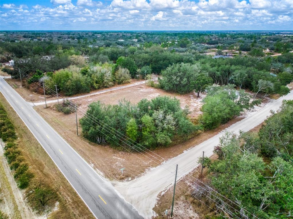 2713 West Hasbrouck Road Avon Park, FL 33825 - Photo 5 of 14 a view of a garden with a building in the background