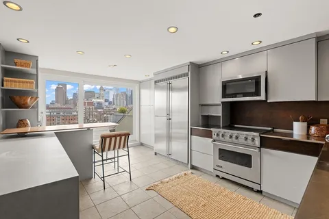 a kitchen with a stove a sink and a microwave