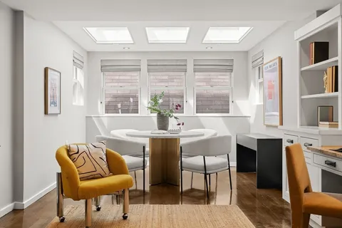 a view of a dining room with furniture and a large window