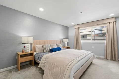 a bedroom with a bed and a window