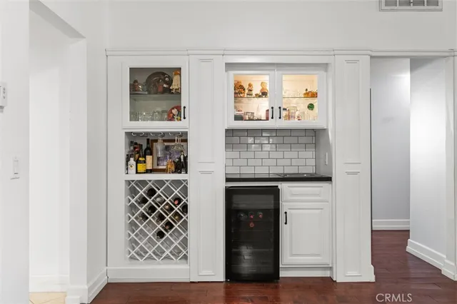 a kitchen with stainless steel appliances granite countertop wooden cabinets a sink dishwasher a stove and a refrigerator