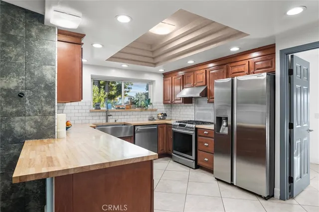 a kitchen with a sink a counter top space and a window