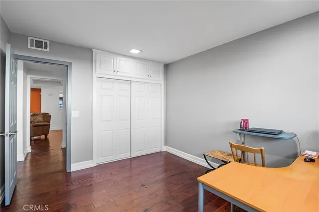 a bathroom with a double vanity sink a toilet and a bathtub