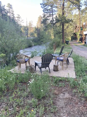 a backyard of a house with lots of green space and seating