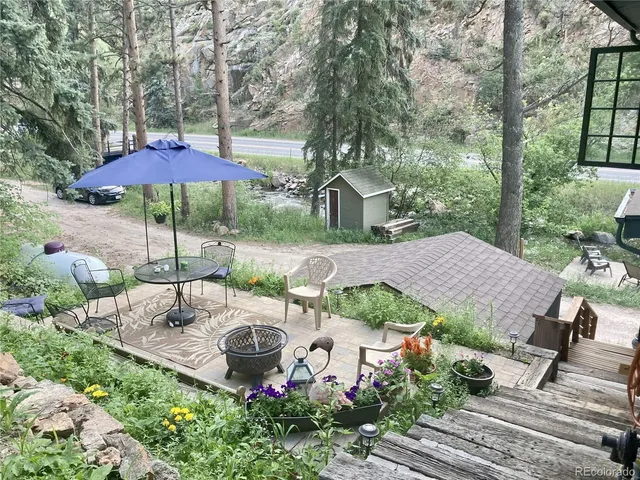 a view of a yard with wooden fence