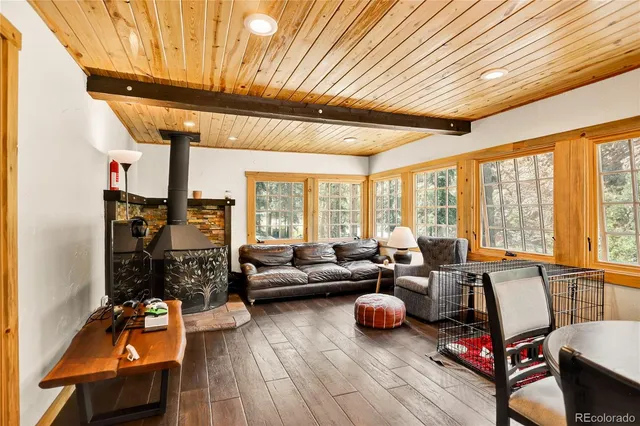 a living room with furniture and large windows