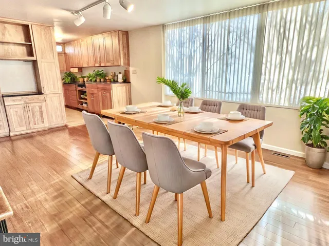 a dining room with furniture and wooden floor