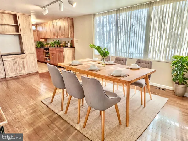 a dining room with furniture and wooden floor