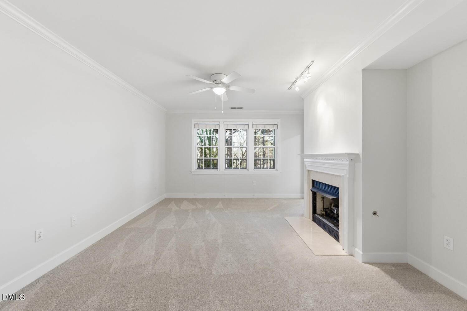 116 Northbrook Drive, Unit 204 Raleigh, NC 27609 - Photo 9 of 94 an empty room with windows fireplace and fans