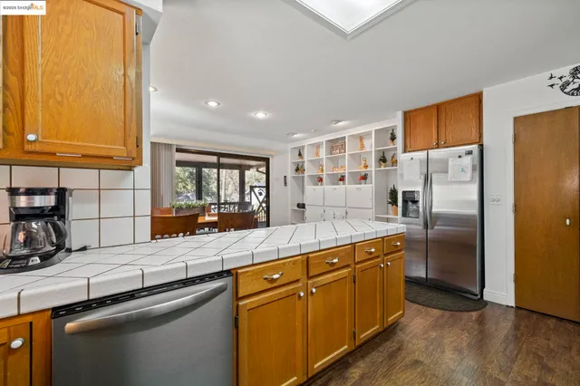 a kitchen with stainless steel appliances granite countertop a refrigerator and a sink