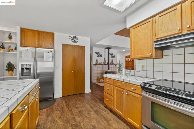 a kitchen with a sink stove and refrigerator