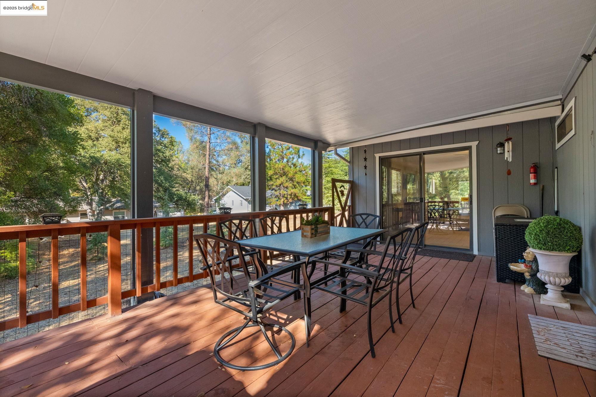 20747 Rising Hill Circle Groveland, CA 95321 - Photo 15 of 60 a view of a porch with furniture and wooden floor