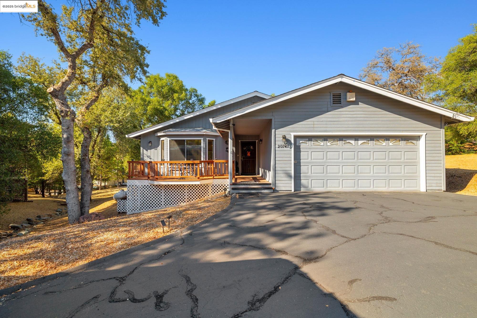 20747 Rising Hill Circle Groveland, CA 95321 - Photo 2 of 60 a front view of a house with a yard