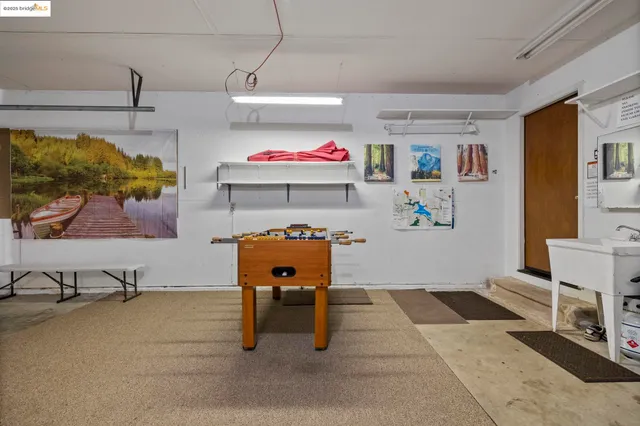 a room with lots of furniture and air hockey table