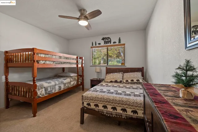 a bedroom with a bed chair and a window
