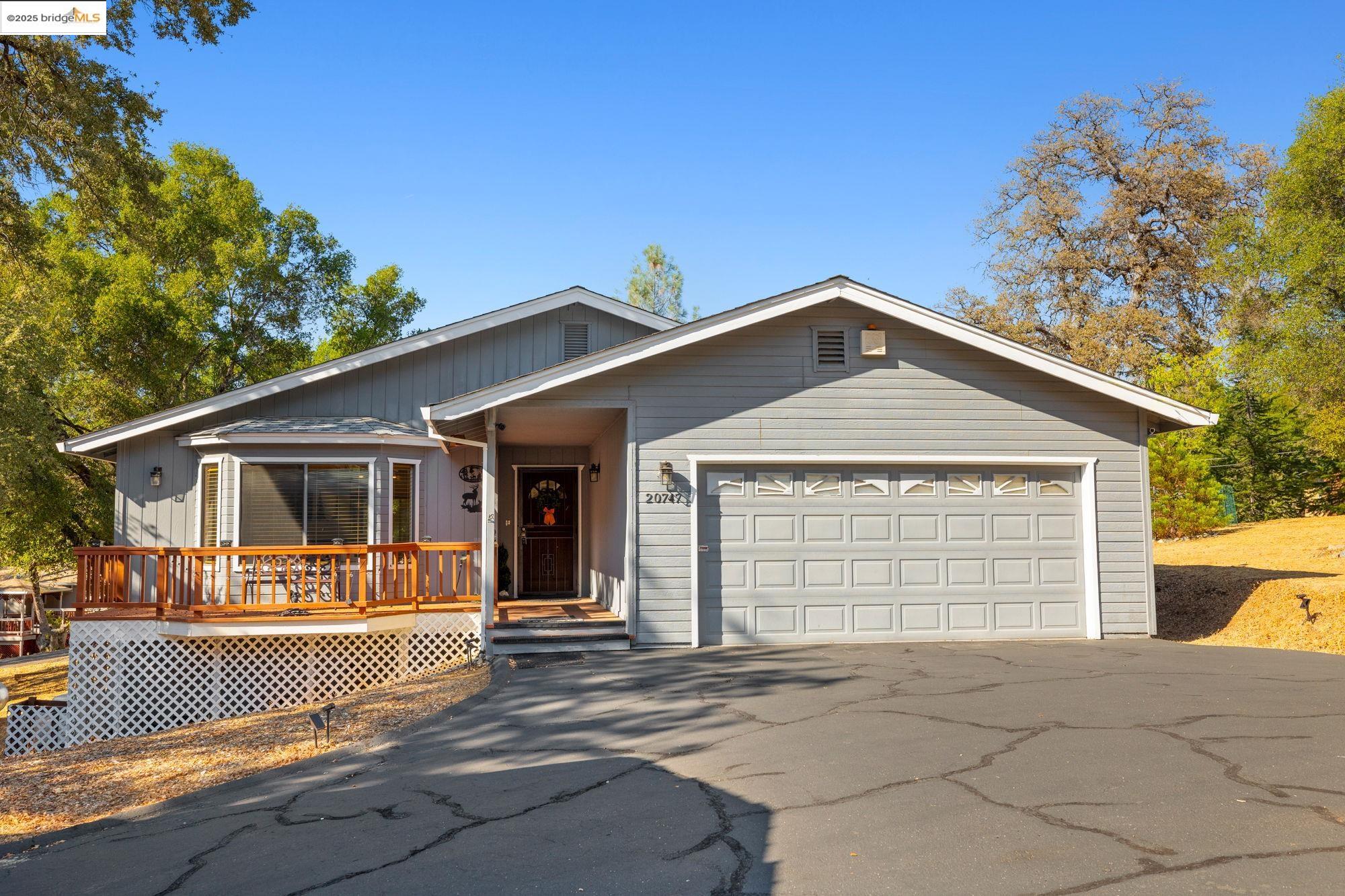 20747 Rising Hill Circle Groveland, CA 95321 - Photo 3 of 60 a front view of house with garage and yard