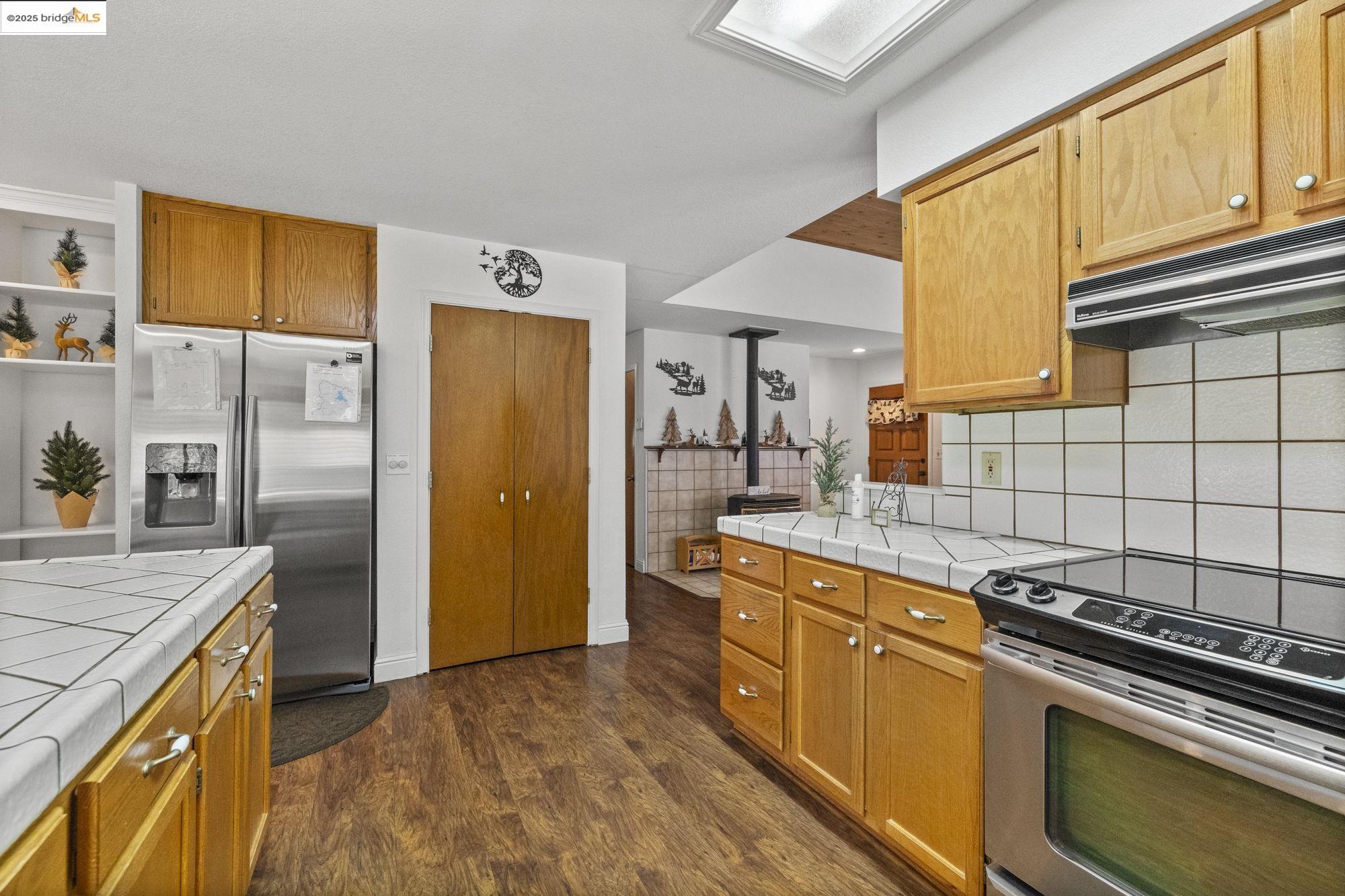20747 Rising Hill Circle Groveland, CA 95321 - Photo 47 of 60 a kitchen with a sink stove and refrigerator