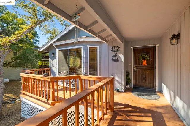 a view of a house with deck and furniture