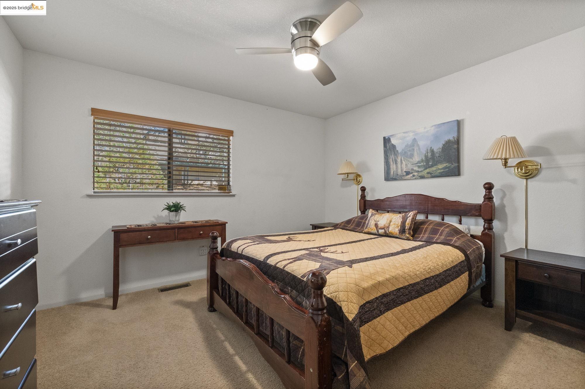 20747 Rising Hill Circle Groveland, CA 95321 - Photo 52 of 60 a bedroom with a bed and a chandelier