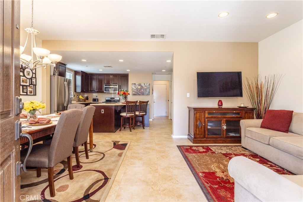 11220 Paseo Sonesta Porter Ranch, CA 91326 - Photo 11 of 46 a living room with furniture a flat screen tv and kitchen view