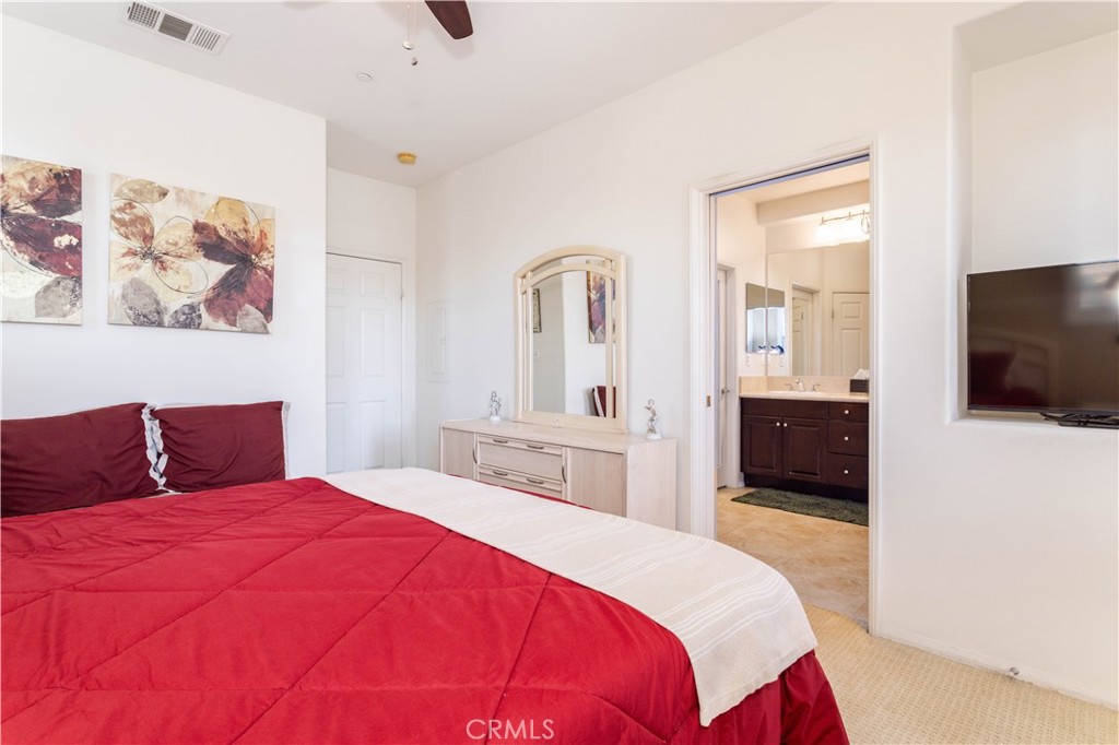 11220 Paseo Sonesta Porter Ranch, CA 91326 - Photo 14 of 46 a bedroom with a large bed and a flat screen tv