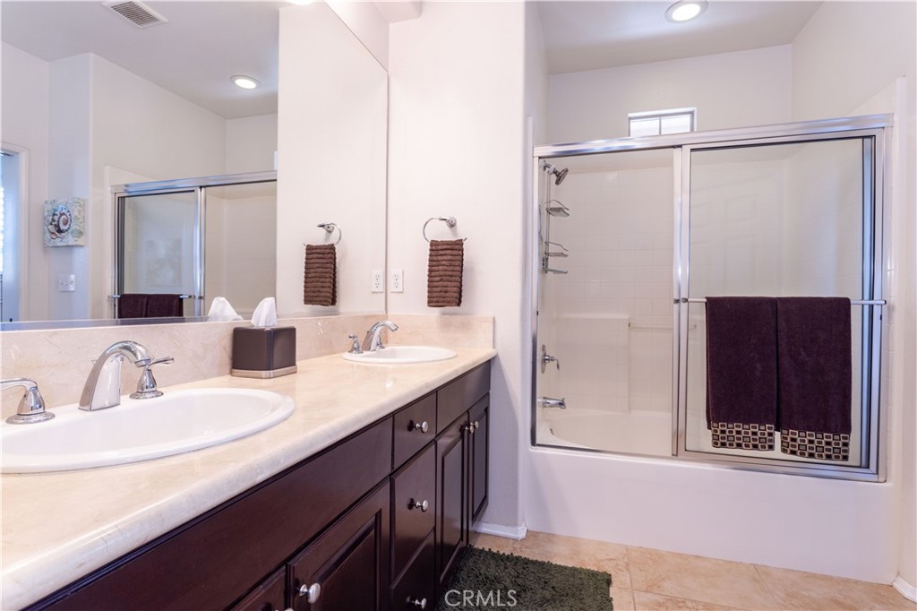 11220 Paseo Sonesta Porter Ranch, CA 91326 - Photo 19 of 46 a bathroom with a double vanity sink and mirror