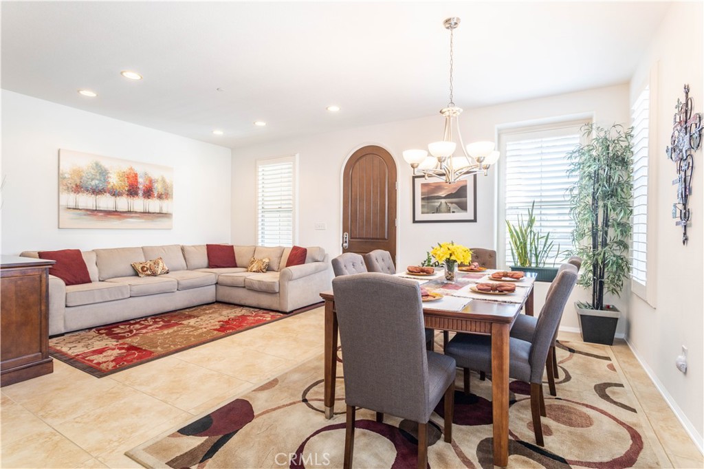 11220 Paseo Sonesta Porter Ranch, CA 91326 - Photo 10 of 46 a living room with furniture a window and a chandelier