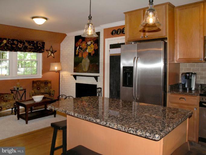 2419 Silver Fox Lane Reston, VA 20191 - Photo 25 of 30 a kitchen with stainless steel appliances granite countertop a sink refrigerator and microwave