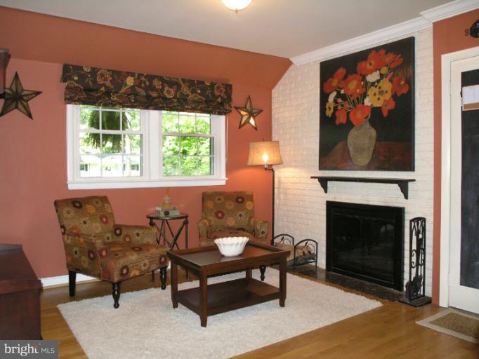 2419 Silver Fox Lane Reston, VA 20191 - Photo 10 of 30 a living room with furniture a fireplace and a large window