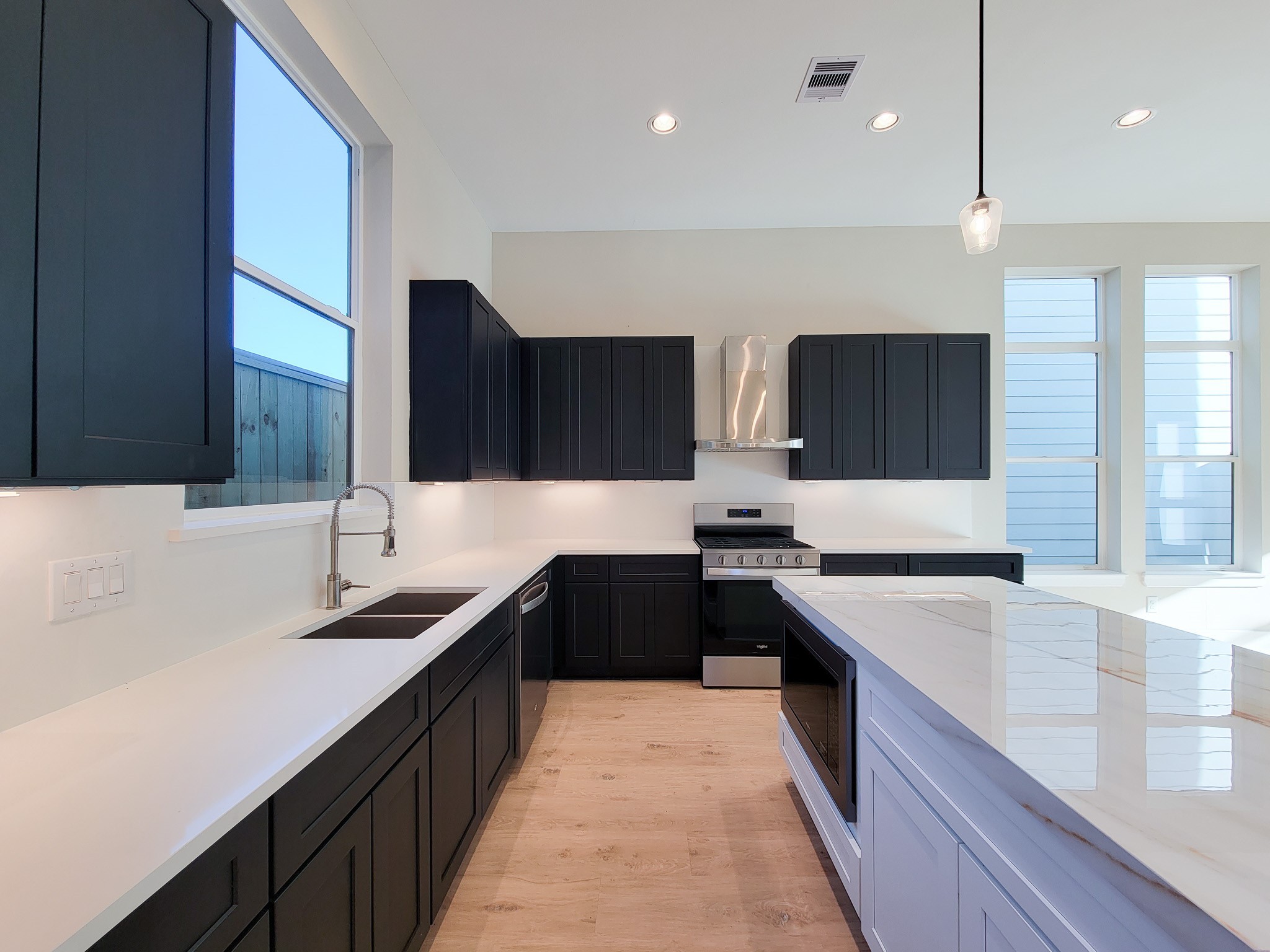 5613 Leonard Street Houston, TX 77023 - Photo 11 of 44 a kitchen with a sink and a stove top oven