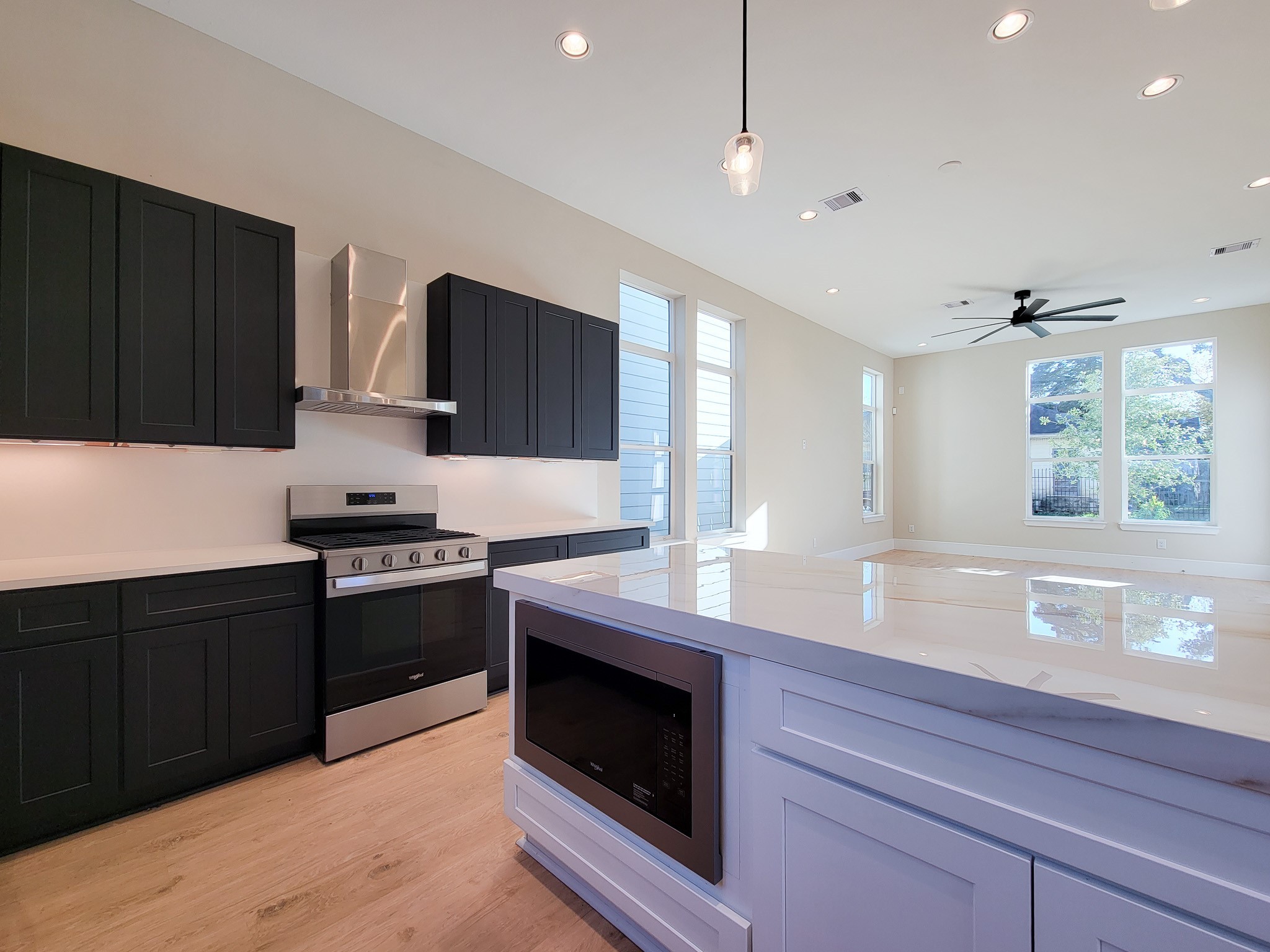 5613 Leonard Street Houston, TX 77023 - Photo 13 of 44 a kitchen with stainless steel appliances granite countertop a stove a sink and a microwave