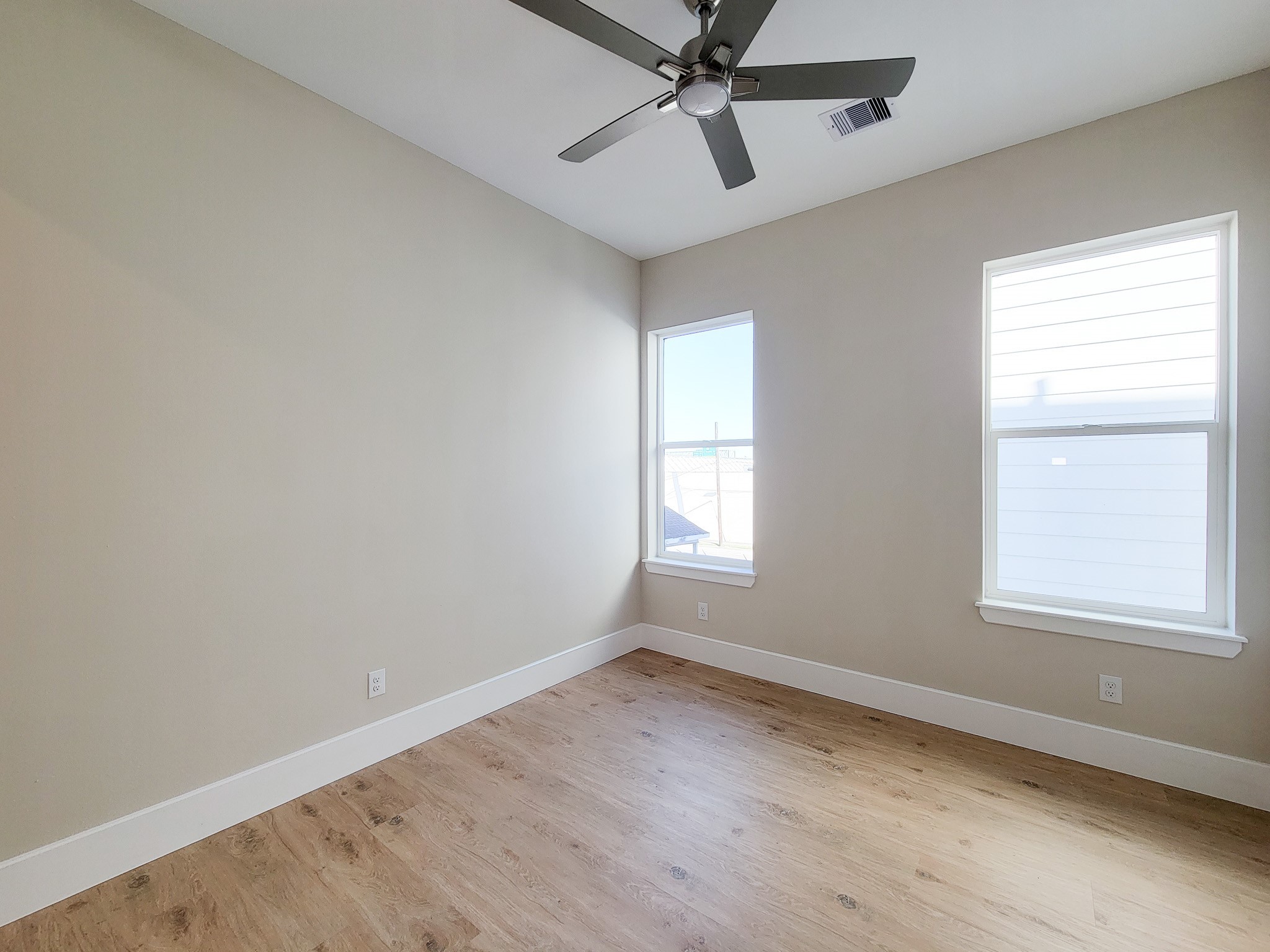 5613 Leonard Street Houston, TX 77023 - Photo 22 of 44 wooden floor in an empty room with a window