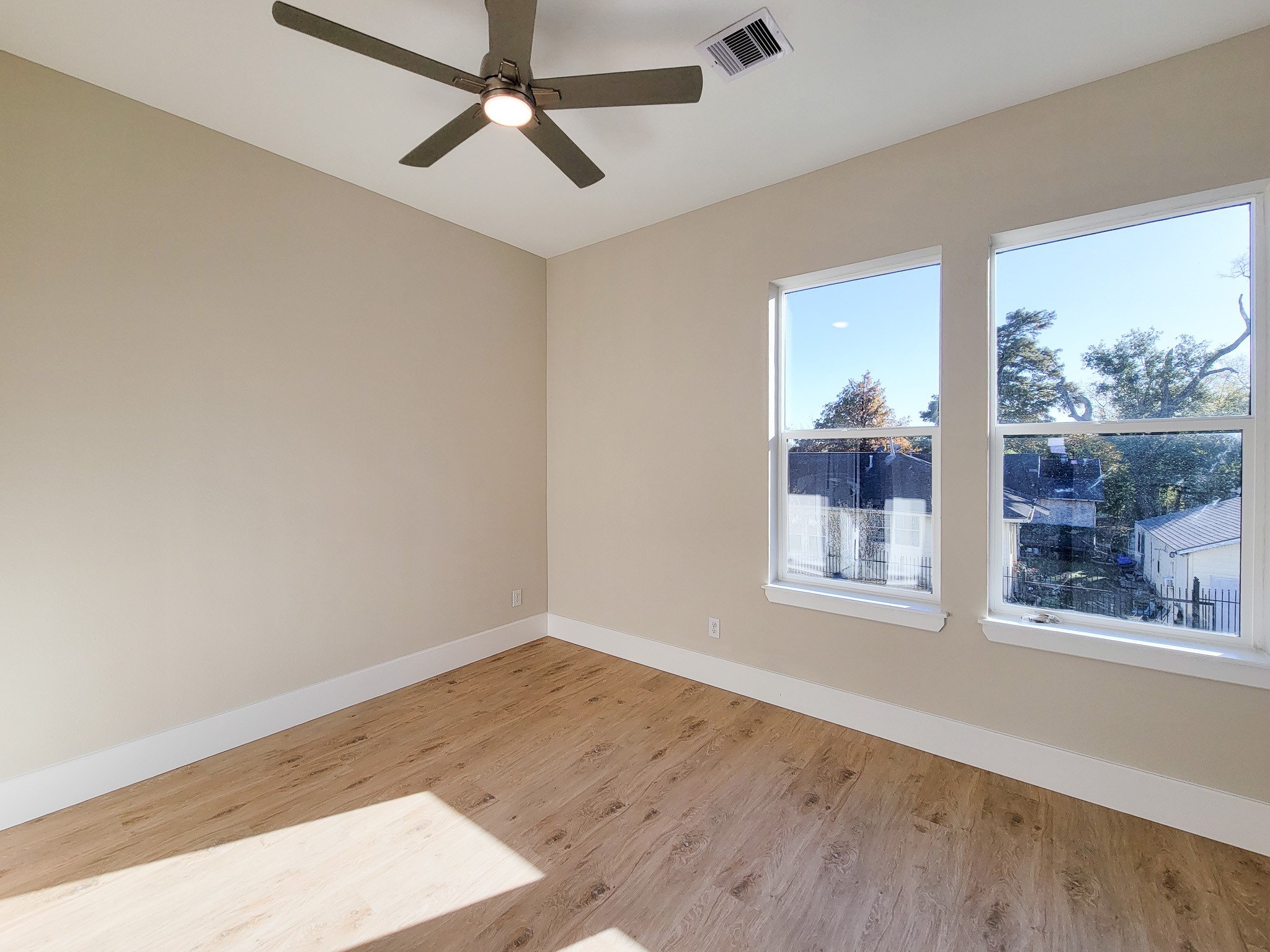 5613 Leonard Street Houston, TX 77023 - Photo 28 of 44 an empty room with wooden floor and windows