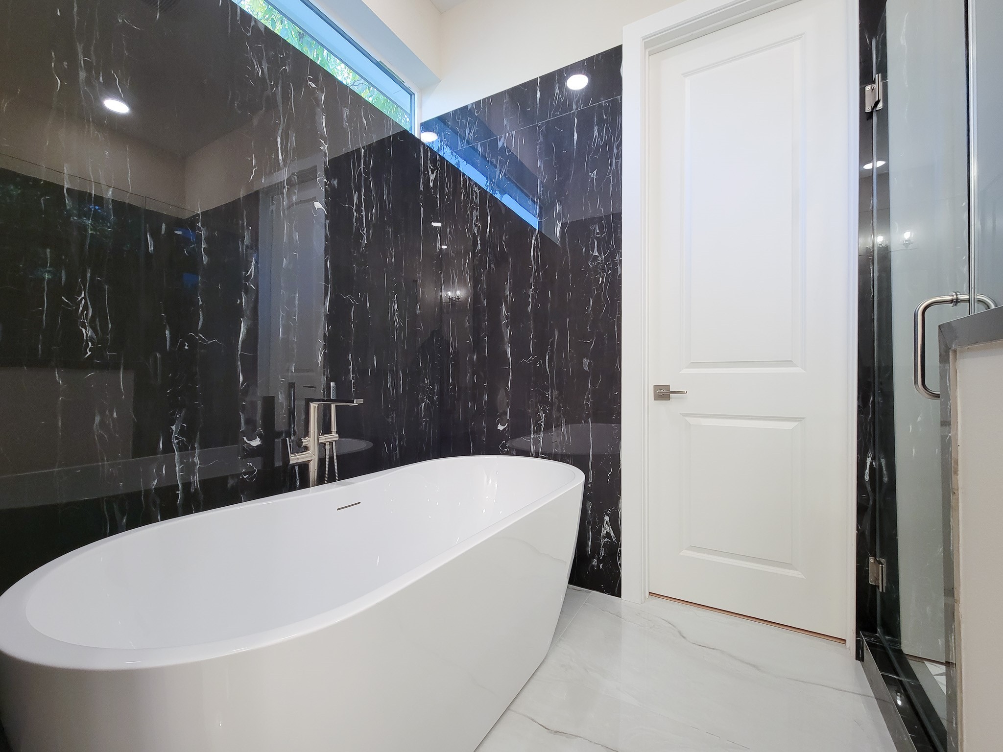 5613 Leonard Street Houston, TX 77023 - Photo 38 of 44 a bathroom with a bathtub and shower