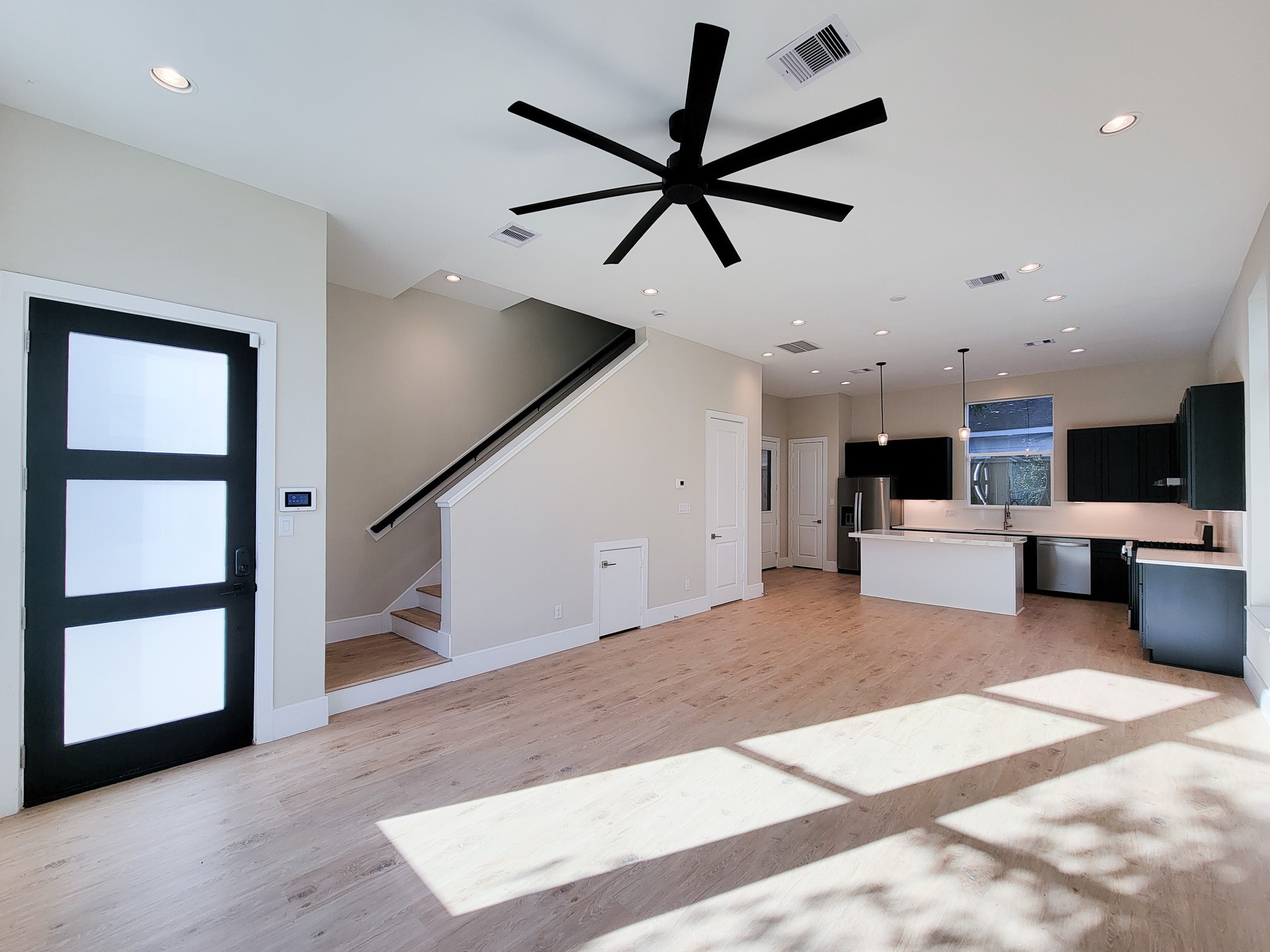 5613 Leonard Street Houston, TX 77023 - Photo 5 of 44 a view of a kitchen with furniture and a ceiling fan