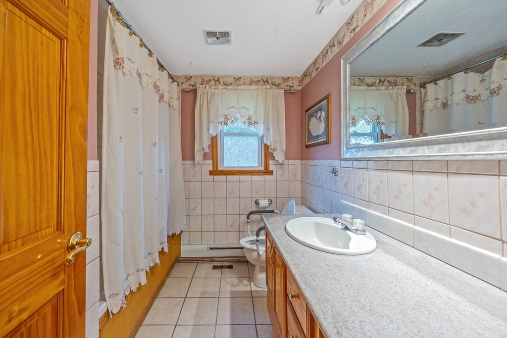 60 Elizabeth Street Feeding Hills, MA 01030 - Photo 16 of 39 a bathroom with a sink a mirror and a bathtub