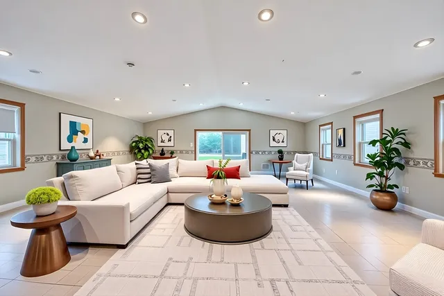 a living room with furniture and flowers