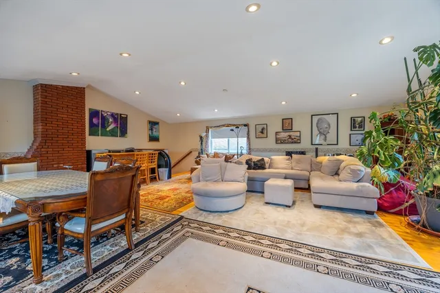 a living room with furniture and flowers