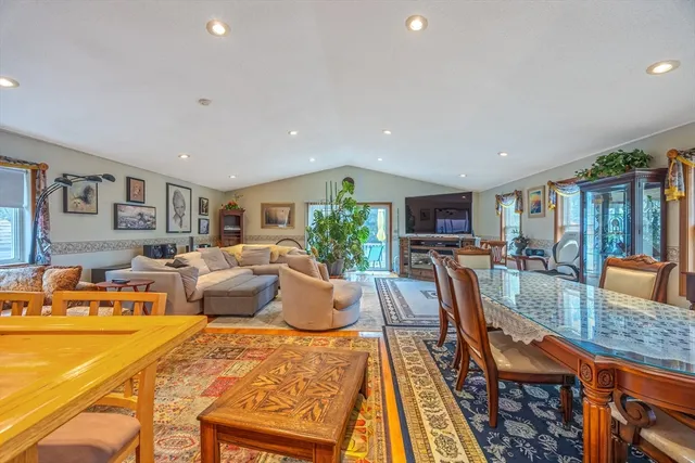 a living room with furniture fireplace and a table