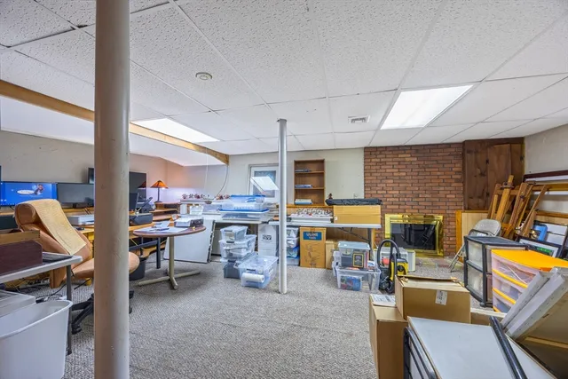 a view of a livingroom with workspace and a window