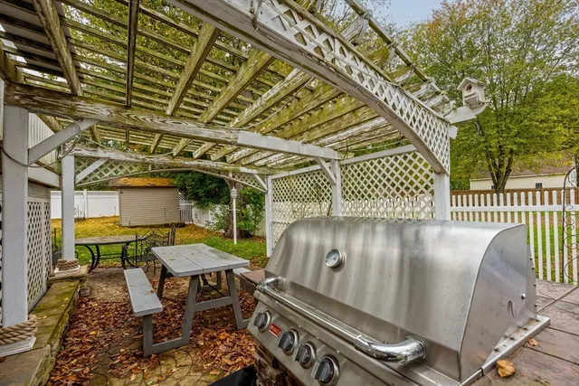a view of a chairs and table in the back yard of the house