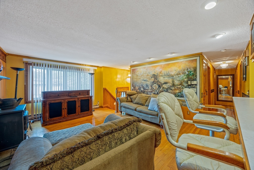 60 Elizabeth Street Feeding Hills, MA 01030 - Photo 3 of 39 a living room with furniture a fireplace and a flat screen tv