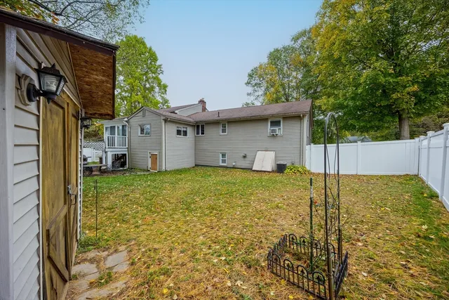 a view of a house with a backyard